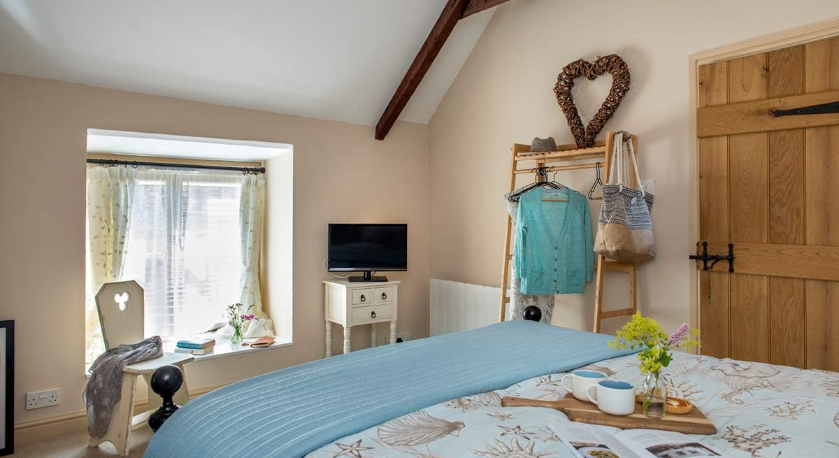 The vaulted ceiling gives the bedroom a great sense of space.