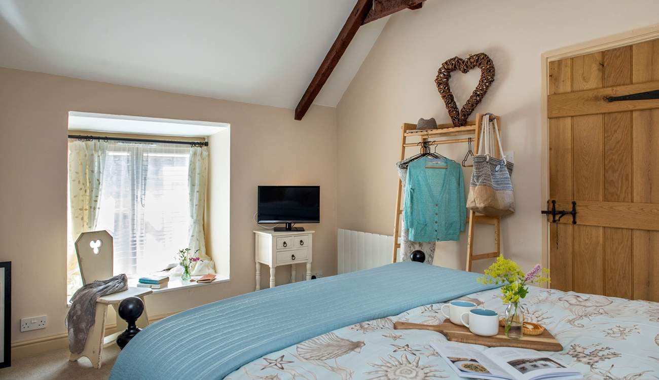 The vaulted ceiling gives the bedroom a great sense of space.