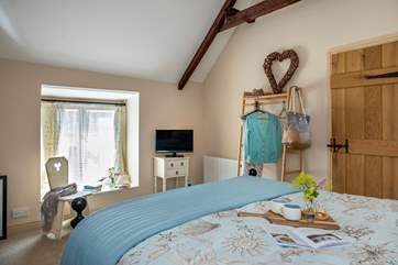 The vaulted ceiling gives the bedroom a great sense of space.