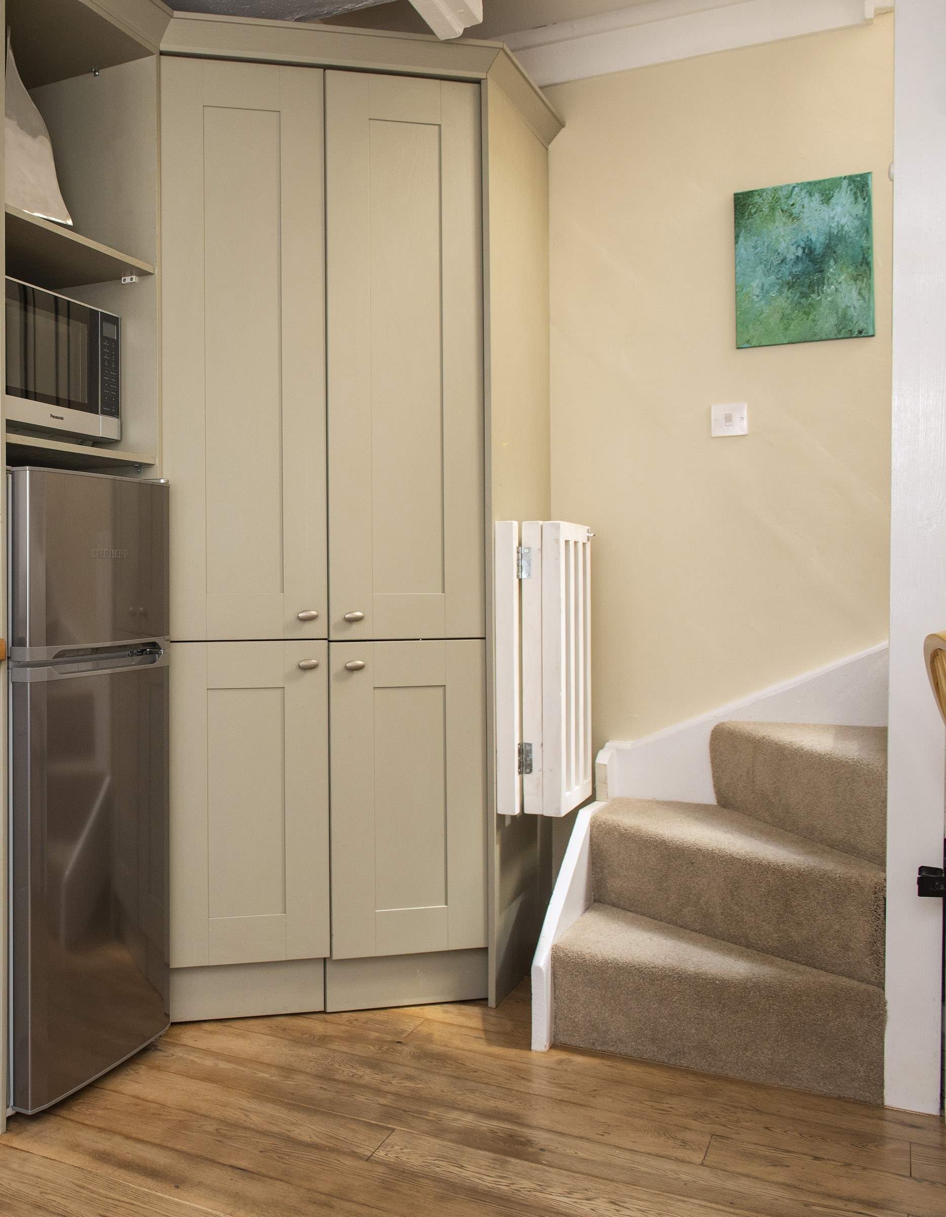 The stairs lead up from the kitchen area.