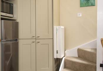 The stairs lead up from the kitchen area.