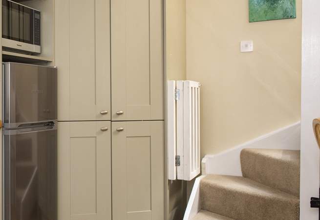 The stairs lead up from the kitchen area.