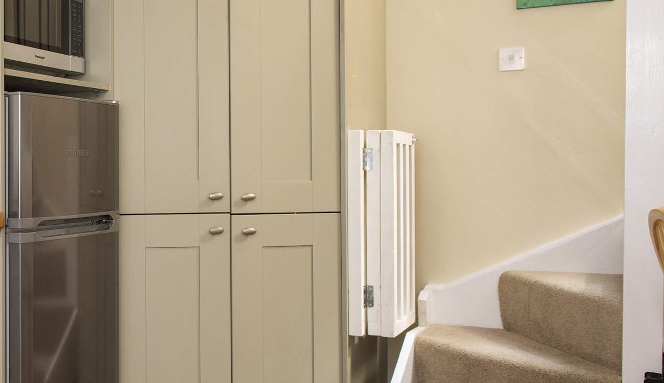 The stairs lead up from the kitchen area.