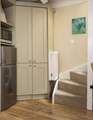 The stairs lead up from the kitchen area.