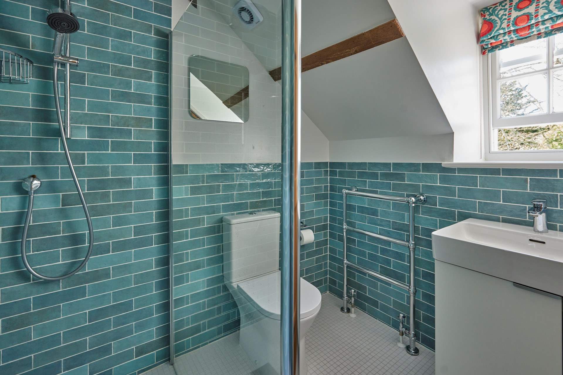 This stylish shower room has an invigouorating rainfall shower.