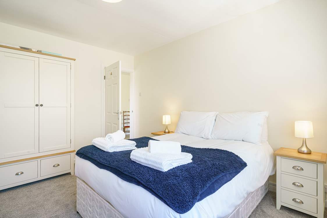 Bedroom 2 on the ground floor, next to the family bathroom with a TV.