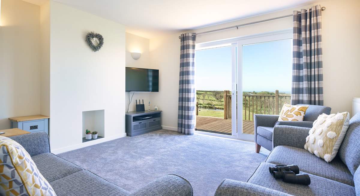 Stylish lounge to relax in with access to the decking and those splendid views.