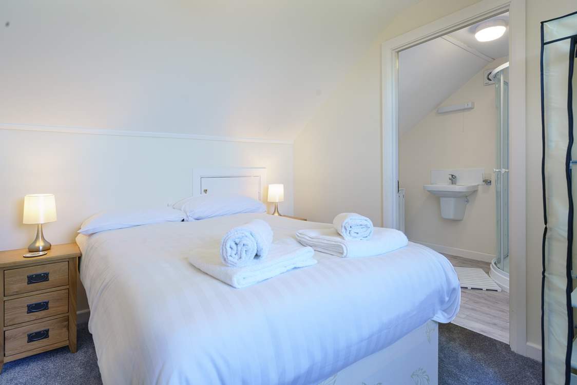 Bedroom 4 with en suite shower-room, small four-foot double bed and glorious views across rolling meadows to the sea and beyond.