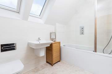 The family bathroom has a shower over the bath.
