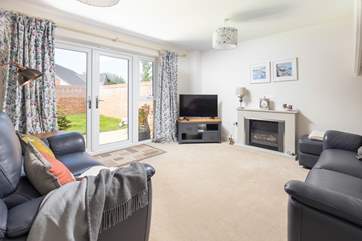The spacious sitting-room with an electric fire for those cooler evenings.