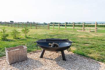 Cook over a wood fire and watch the sky turn to a soft palette of summer hues.