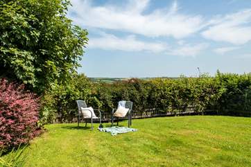 There is a lawn area to the side, the perfect spot to sit and enjoy the sunshine.