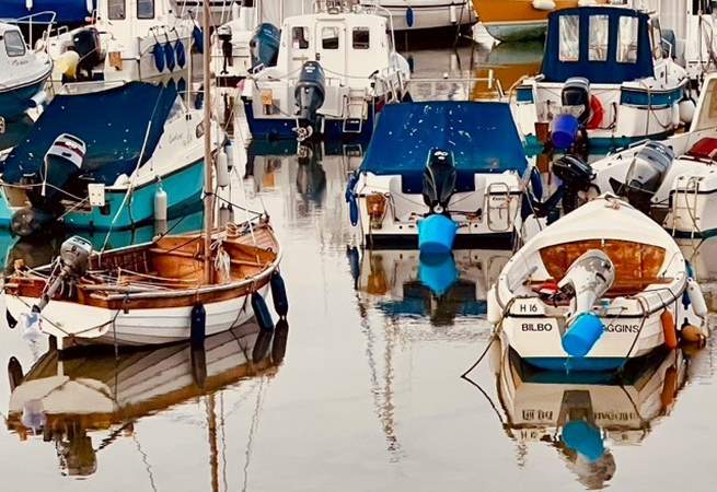 Colourful boats in the harbour at Lyme Regis.