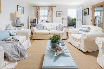The comfy sitting-room has access to the decking area, ideal for morning coffee.