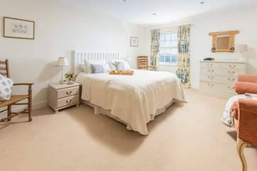 Spacious bedroom 1 is the perfect place to sit and watch the ocean.