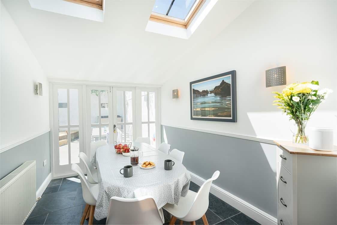 The dining-area leads out to the sunny courtyard and is flooded with light.