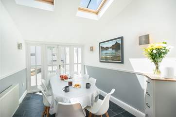 The dining-area leads out to the sunny courtyard and is flooded with light.
