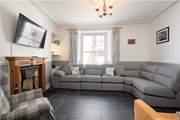 The cosy sitting-room is perfect for relaxing in after a full day at the beach.