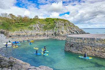 Make the sea a part of your holiday and try stand up paddle boarding at Stackpole Quay.