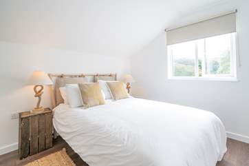 The comfortable double bedroom has lovely views facing across the rear of the apartment.