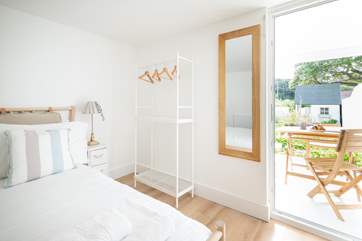 The light and airy main bedroom offers the benefit of a door leading out to the pretty garden.