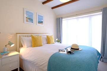 Bedroom one has French doors and looks out across the gravelled courtyard.