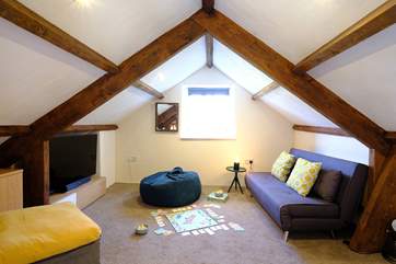The snug on the mezzanine is great for a family movie night. Take care with the sloping ceilings and low beams.
