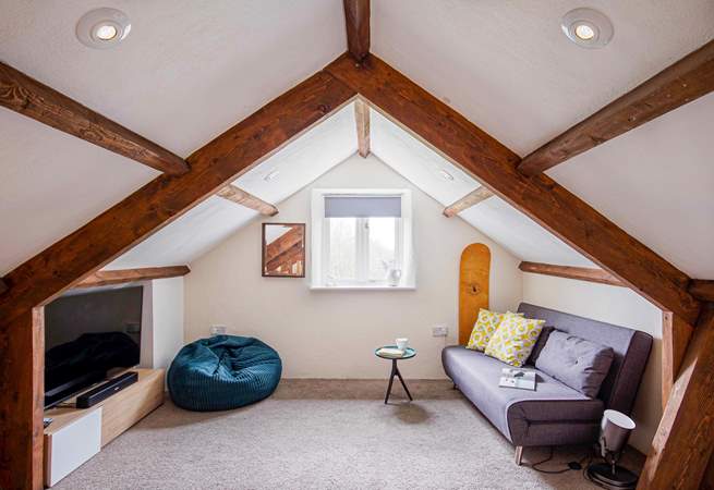 The snug on the mezzanine is great for a family movie night. Take care with the sloping ceilings and low beams.