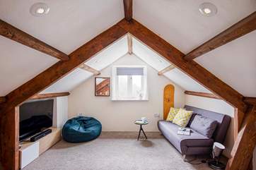 The snug on the mezzanine is great for a family movie night. Take care with the sloping ceilings and low beams.