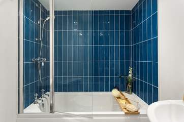 There is an overhead shower in the bath in the main bathroom.