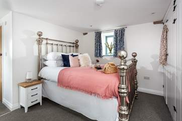 Bedroom one on the ground floor has a king-size bed and en suite shower-room.
