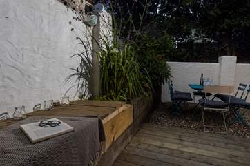 The wooden planters provide the perfect place to perch with a book.