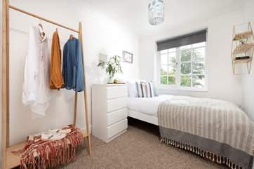 Bedroom 2 has a single bed and is prettily furnished.