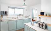 The gorgeous kitchen has cool and calming tones, perfect for a house by the sea! - Thumbnail Image