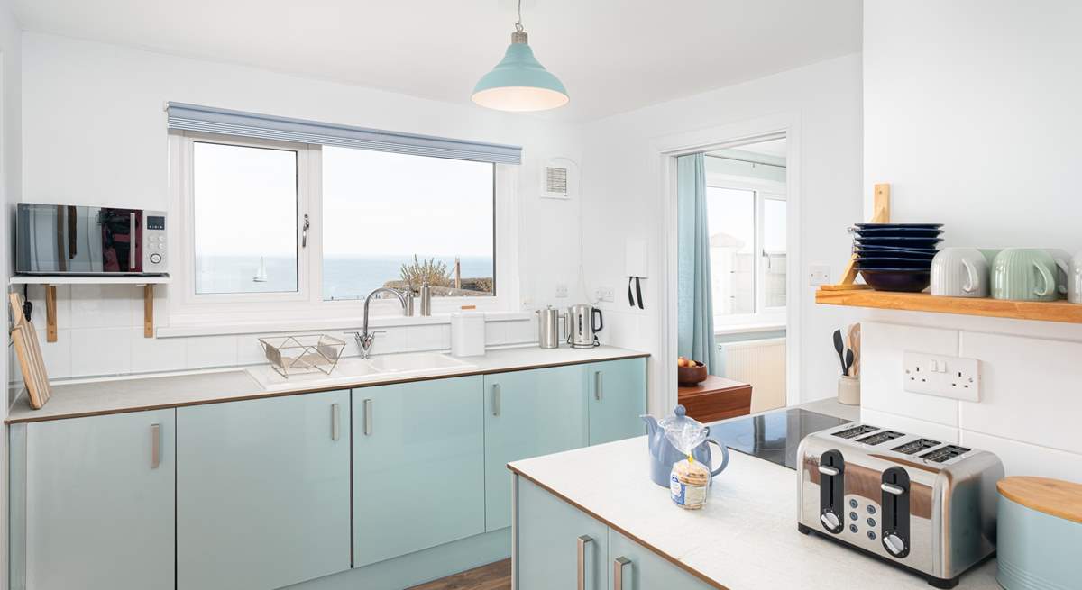 The gorgeous kitchen has cool and calming tones, perfect for a house by the sea!