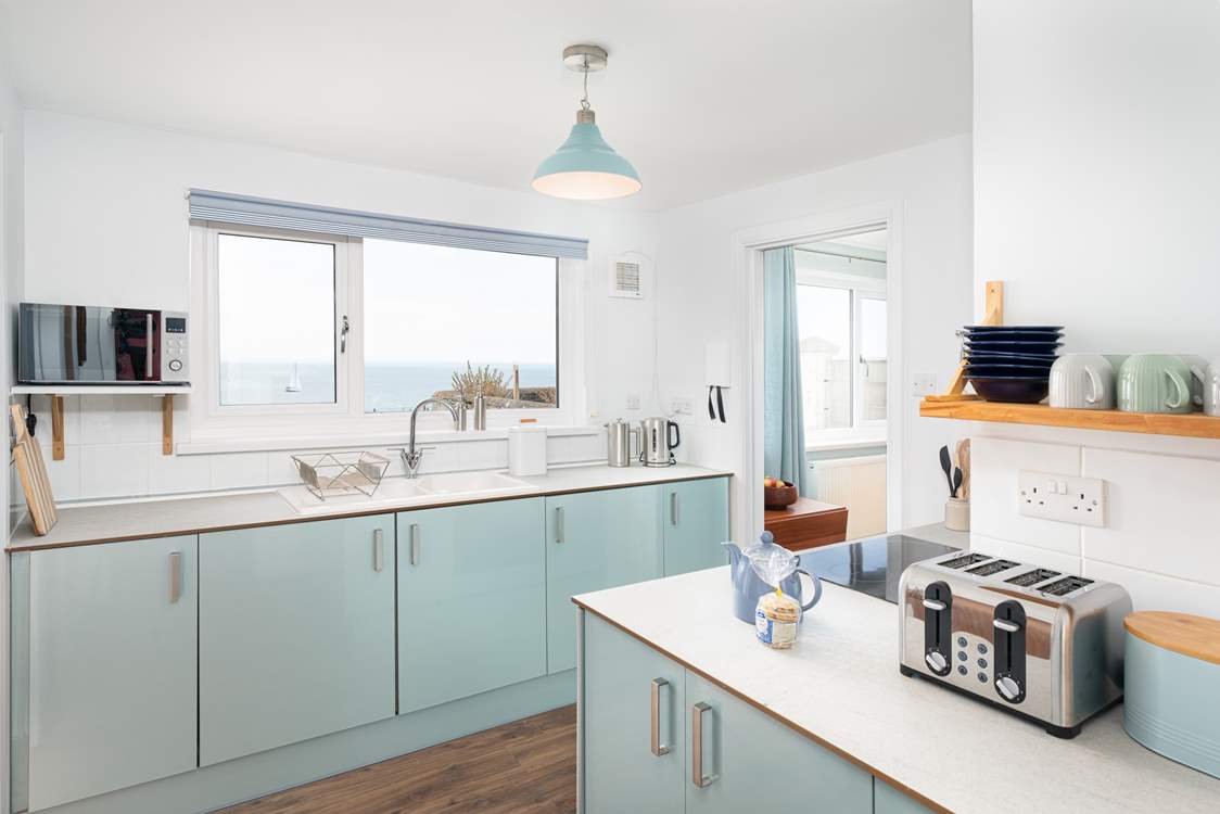The gorgeous kitchen has cool and calming tones, perfect for a house by the sea!