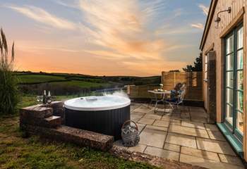 What a magical spot, sink back and relax in the cute hot tub for two. 
