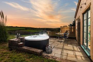 What a magical spot, sink back and relax in the cute hot tub for two.