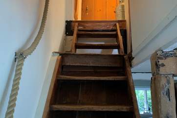 Steep stairs lead to the bedrooms and bathroom.