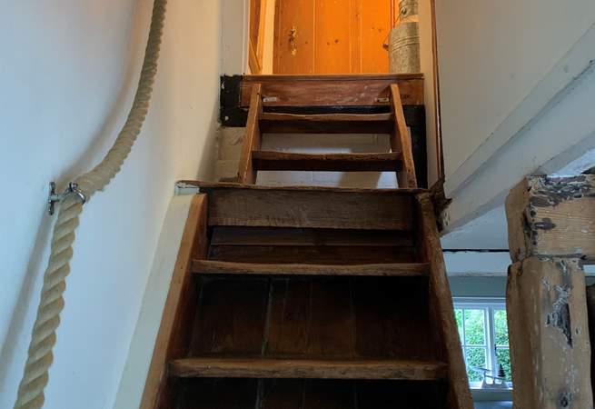 Steep stairs lead to the bedrooms and bathroom.