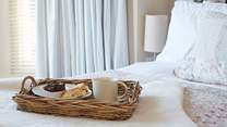 The pretty main bedroom with its comfy bed and morning treats.