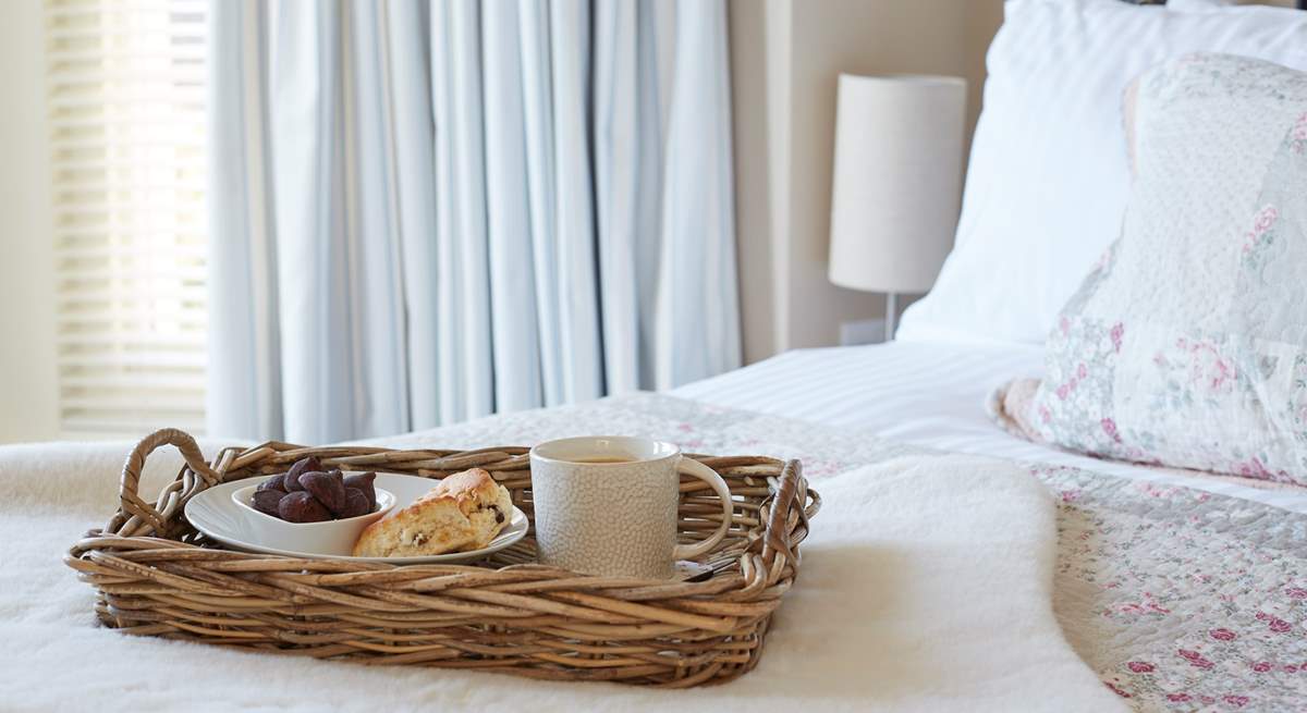 The pretty main bedroom with its comfy bed and morning treats.