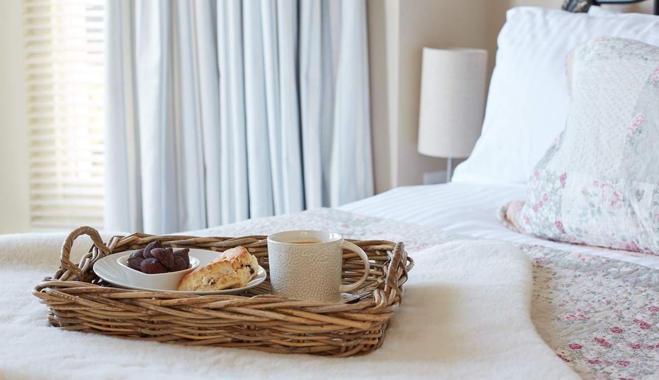The pretty main bedroom with its comfy bed and morning treats.