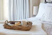 The pretty main bedroom with its comfy bed and morning treats.