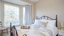 The pretty main bedroom is furnished with a king-size double bed.