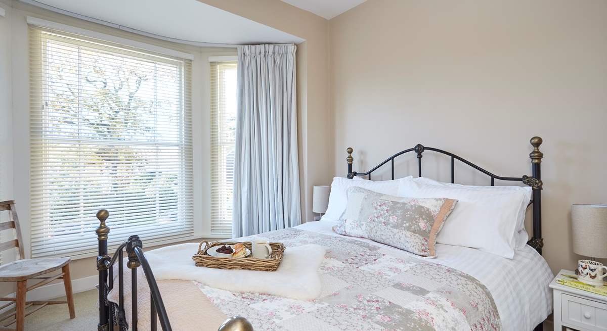 The pretty main bedroom is furnished with a king-size double bed.