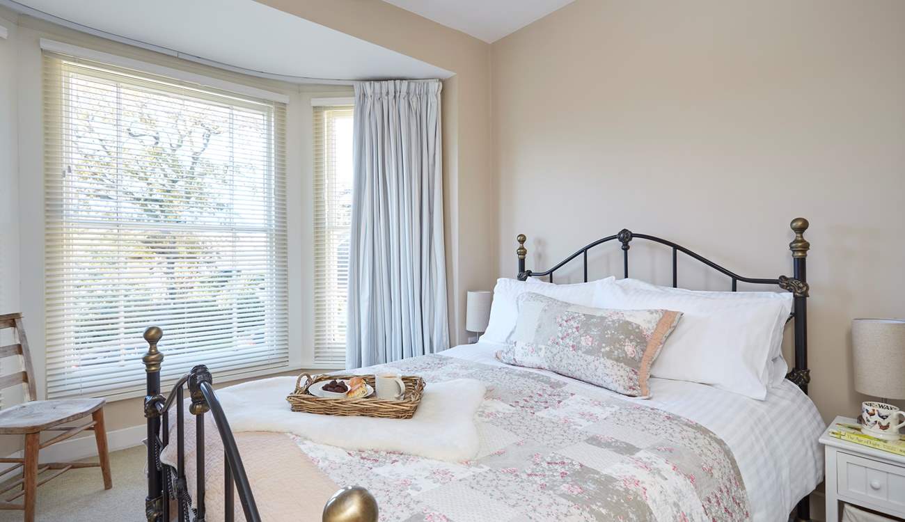 The pretty main bedroom is furnished with a king-size double bed.
