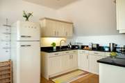The stylish kitchen comes complete with a retro style SMEG fridge/freezer.
