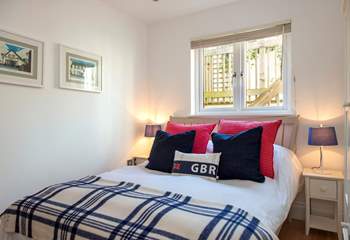 The lovely double bedroom dressed in nautical colours is on the ground floor.