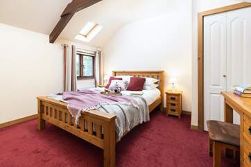 The bedroom has a king-size bed and built-in wardrobe.